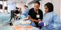 Julia Iyasere, MD, left, works with a student in the simulation center in the Vagelos Education Center. Photo by Jörg Meyer.